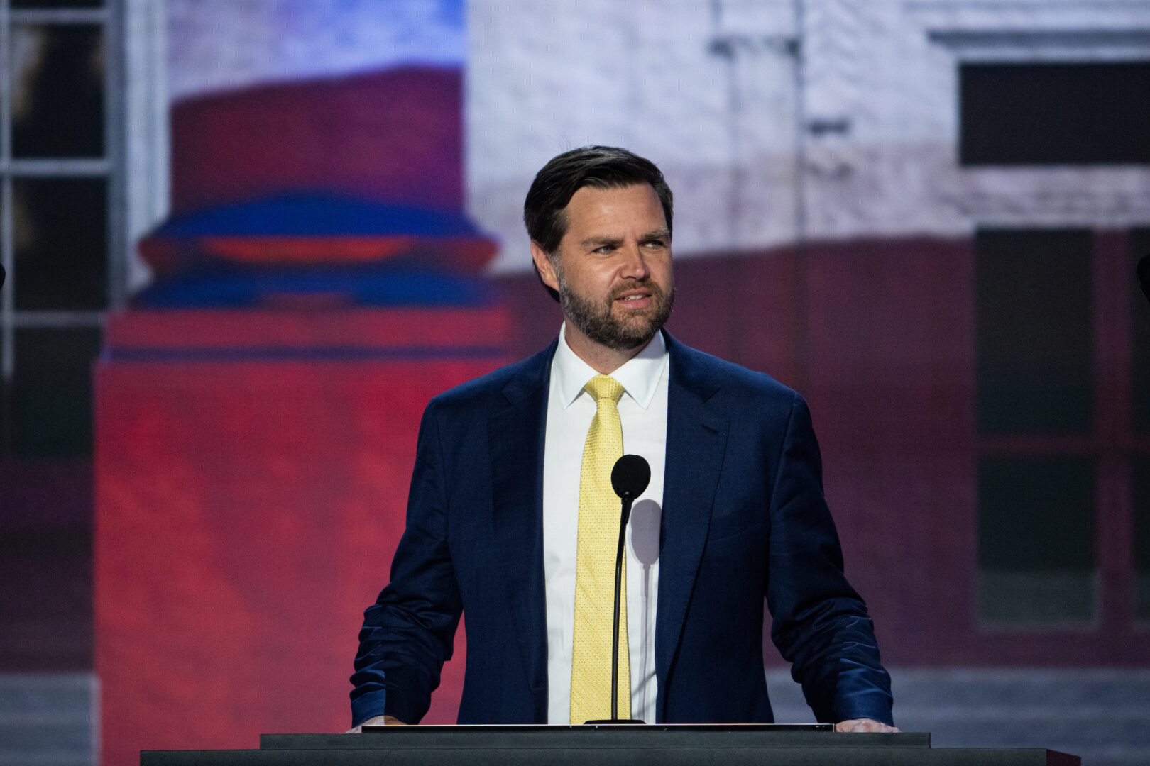 Sen. JD Vance appears on stage for a podium check at the Fiserv Forum before the start of the Tuesday session of the Republican National Convention.