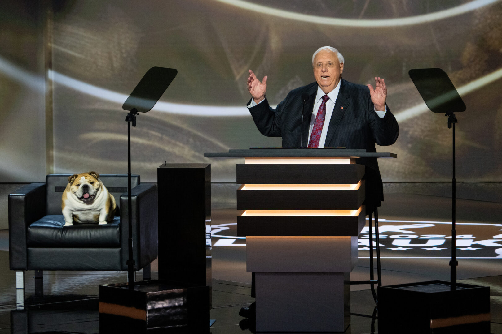 Senate candidate Jim Justice, West Virginia's governor, speaks as his English bulldog, Babydog, sits in a chair on stage at the Republican National Convention in Milwaukee on Tuesday.