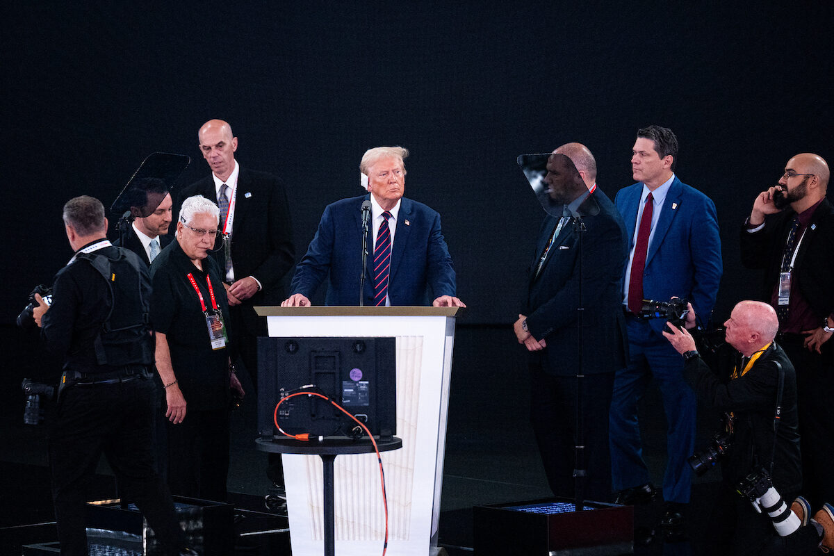 Former President Donald Trump stands on stage for a podium check at the Fiserv Forum on Wednesday afternoon. (Bill Clark/CQ Roll Call)