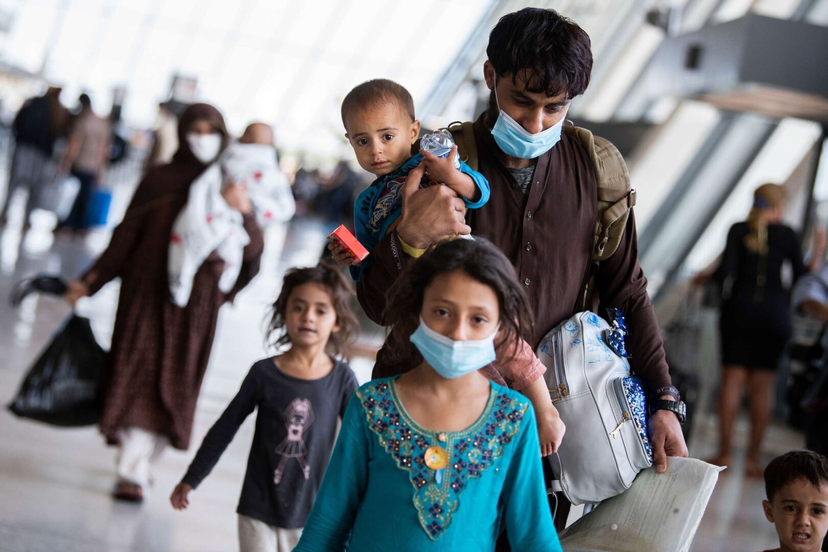 Afghan refugees arrive at Dulles International Airport on Aug. 27, 2021, after Afghanistan fell to the Taliban. Some 36,000 evacuees are now without a clear path to permanent residency in the U.S.