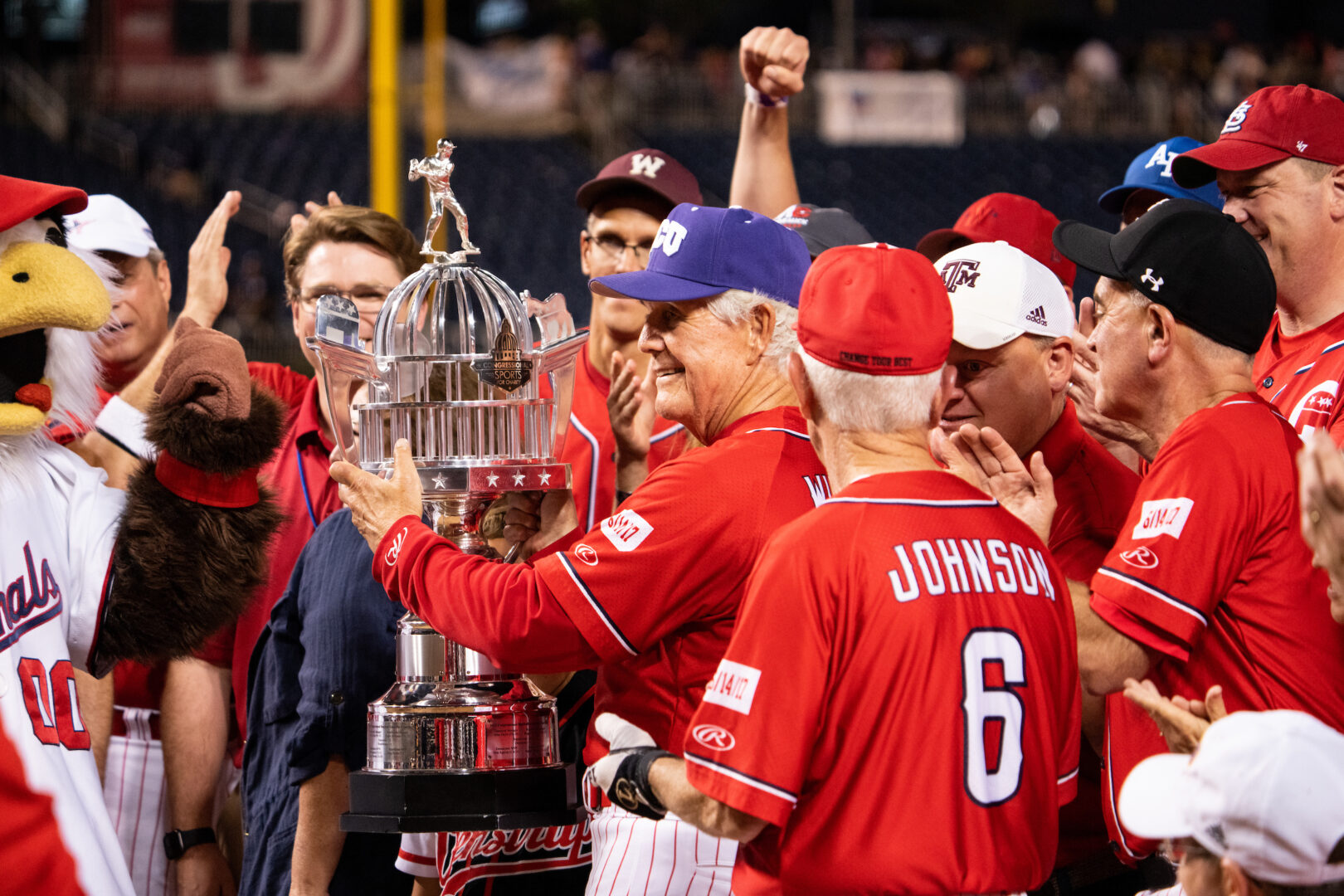 Rep. Roger Williams holds a trophy after coaching the GOP team to a win in the 2023 Congressional Baseball Game. “Why would an environmentalist not like a baseball game?” he replied when asked about climate protesters who plan to disrupt this year’s game.