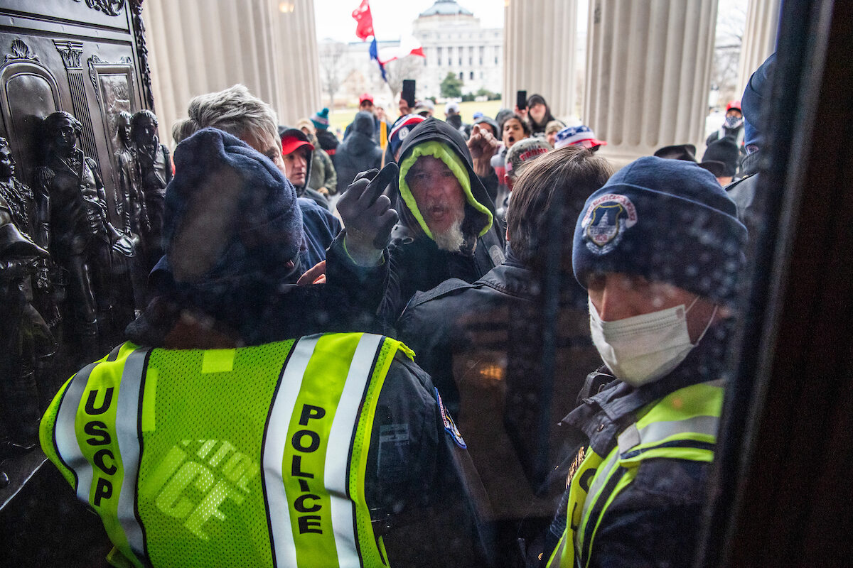 Rioters attempt to enter the Capitol at the House steps during a joint session of Congress to certify the Electoral College vote on Jan. 6, 2021.