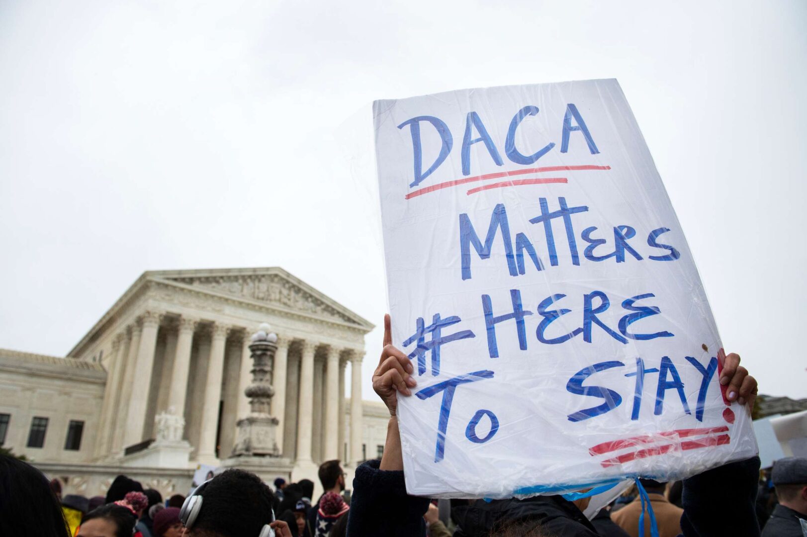 A protester holds up a sign during a rally outside the U.S. Supreme Court on Nov. 12, 2019, as justices were hearing arguments on the Trump administration’s decision to end the Deferred Action for Childhood Arrivals program.