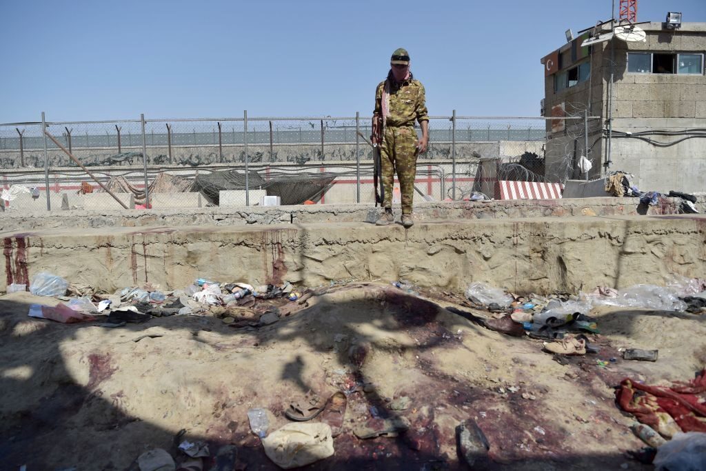 A Taliban fighter stands guard at Kabul airport on Aug. 27, 2021, at the site of the twin suicide bombs that killed scores of people, including 13 U.S. troops, the previous day.