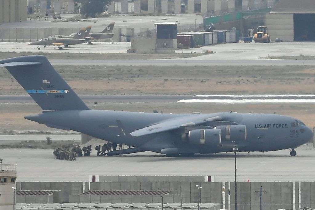 U.S. troops board an Air Force plane at the airport in Kabul, Afghanistan, on Aug. 30, 2021.