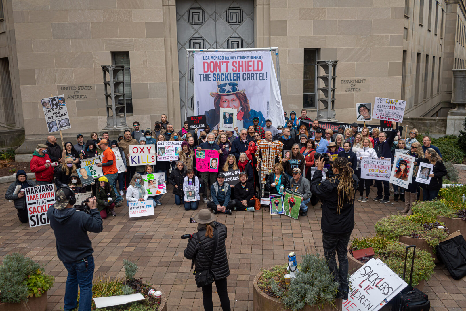 People from across the United States who lost loved ones because of the opioid epidemic rallied at the Justice Department in Washington on Dec. 3, 2021. 