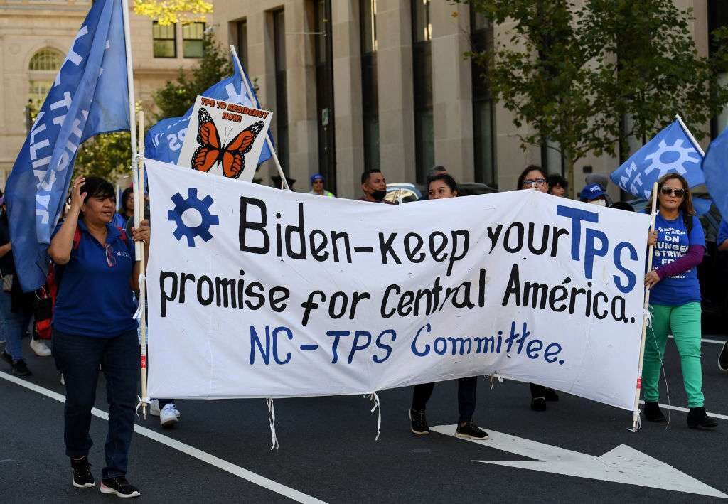 Activists and citizens with Temporary Protected Status march in September near the White House for residency protections. 