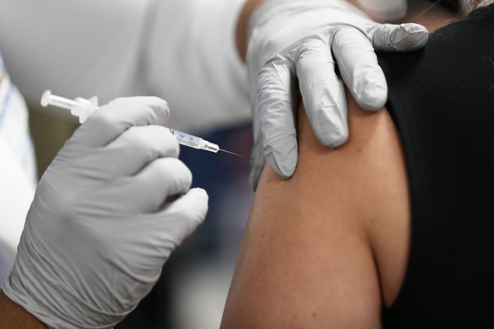 A health care worker  receives a COVID-19 vaccine at the Jackson Memorial Hospital  in Miami.