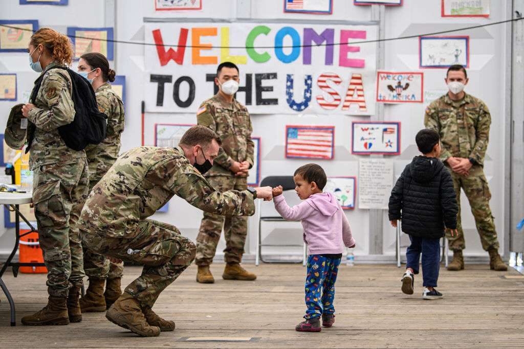 Evacuees from Afghanistan wait for boarding into a passenger plane bound for the U.S. at the U.S. military's Ramstein air base in Germany in October. At least 11,000 Afghan evacuees flown of out of Kabul by the U.S. military following the fall of Afghanistan to the Taliban had been living in temporary accommodation at U.S. military bases in Germany over recent weeks, their journey onward delayed due to their mass vaccination against Covid-19.