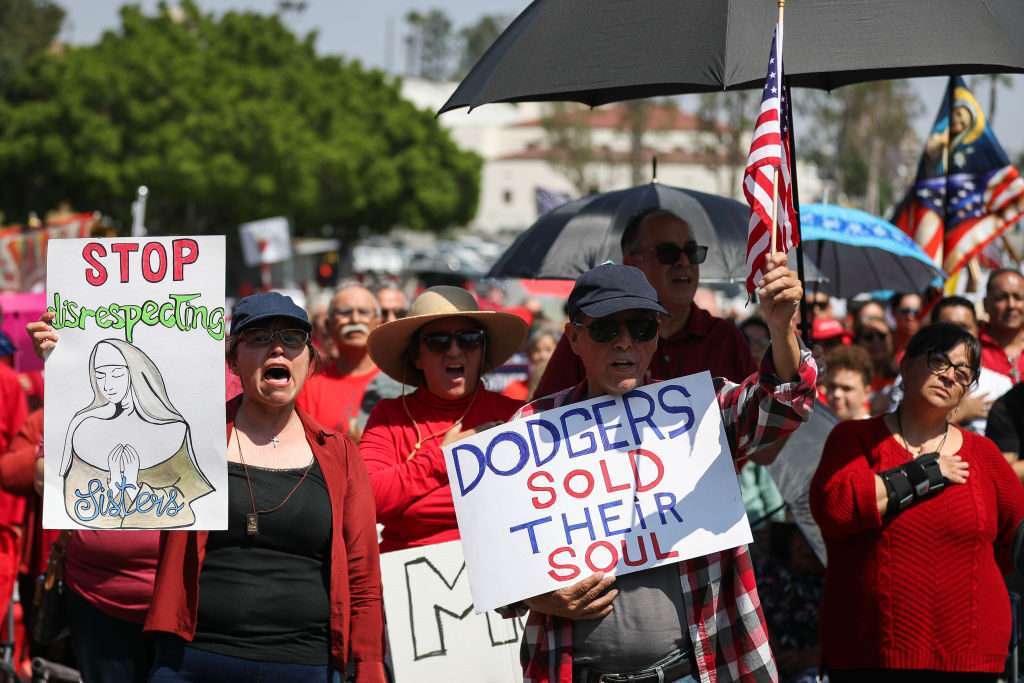 Protesters hold signs at a Catholics for Catholics event in response to the Dodgers' Pride Night event including the Sisters of Perpetual Indulgence prior to the game between the San Francisco Giants and the Los Angeles Dodgers at Dodger Stadium on June 16 in Los Angeles. 