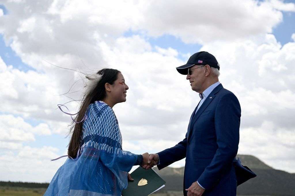 Maya Tilousi, member of the Hopi Tribe, Havasupai Tribe of Grand Canyon and the Cheyenne and Arapaho tribes, shakes hands with President Joe Biden at Red Butte Airfield in Arizona on Tuesday. Biden put the brakes on uranium mining around the Grand Canyon by giving an area of nearly 1 million acres national monument status.