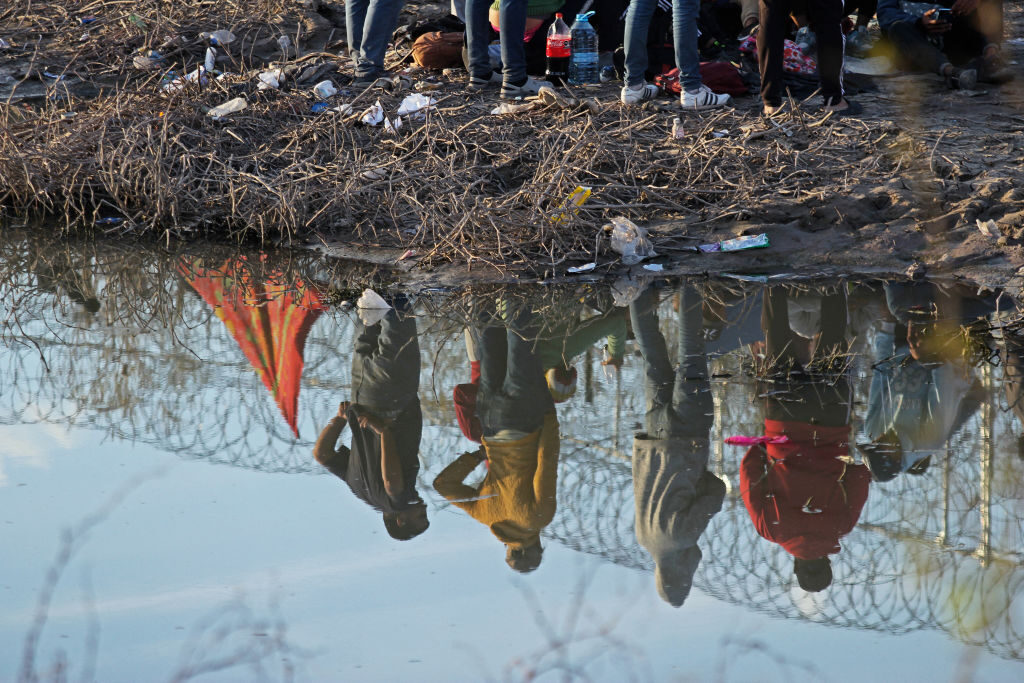 Migrants seeking asylum in the United States wait Thursday on the border of Ciudad Juarez, Chihuahua state, Mexico. Migrants stranded in Mexico were informed that the U.S. Supreme Court has authorized a Texas law that allows state authorities to detain foreigners without papers. 