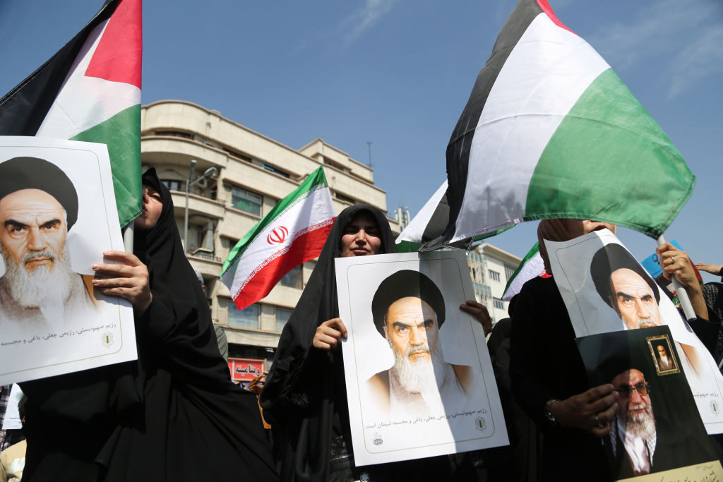 People march in Tehran with Palestinian and Iranian flags and banners to celebrate Iran's April 13 attack on Israel and protest Israel, which Iran accused of carrying out an attack on its soil six days later.