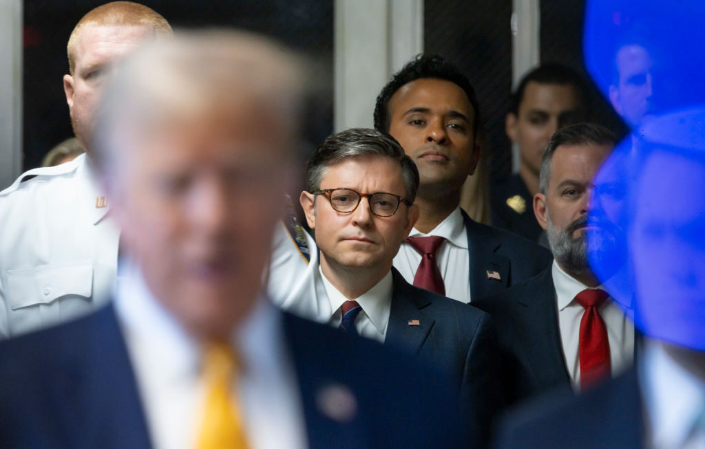 Speaker Mike Johnson, R-La., center, and businessman Vivek Ramaswamy, third from left, listen Tuesday as former President Donald Trump arrives for his trial for allegedly covering up hush money payments linked to an extramarital affair.