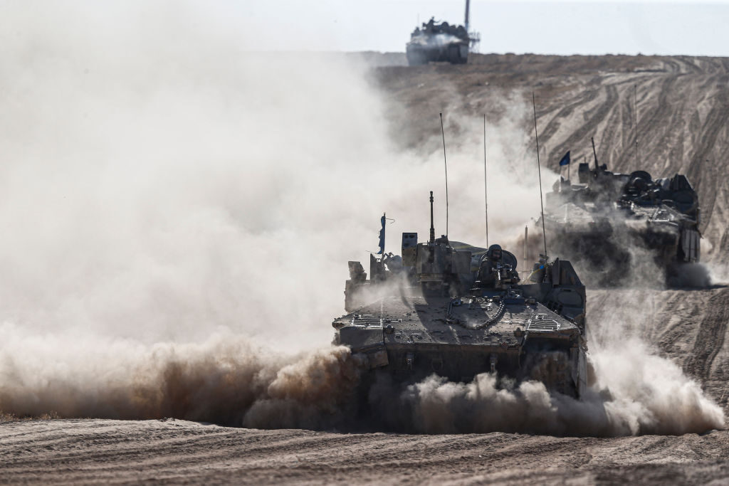 Israeli tanks, armored personnel carriers, trucks and other vehicles drive near the city of Rafah, Gaza, on Wednesday.