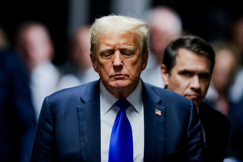 Former President Donald Trump departs a courtroom after being found guilty on all 34 counts in his criminal hush money trial in New York on Thursday, flanked by attorney Todd Blanche. (Justin Lane-Pool/Getty Images)