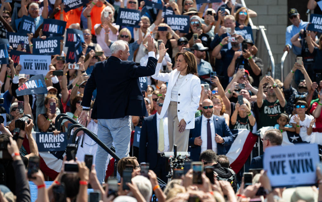 Democratic presidential candidate and Vice President Kamala Harris and running mate Tim Walz, the governor of Minnesota, greet each other on stage during a campaign rally on Wednesday in Eau Claire, Wis. 