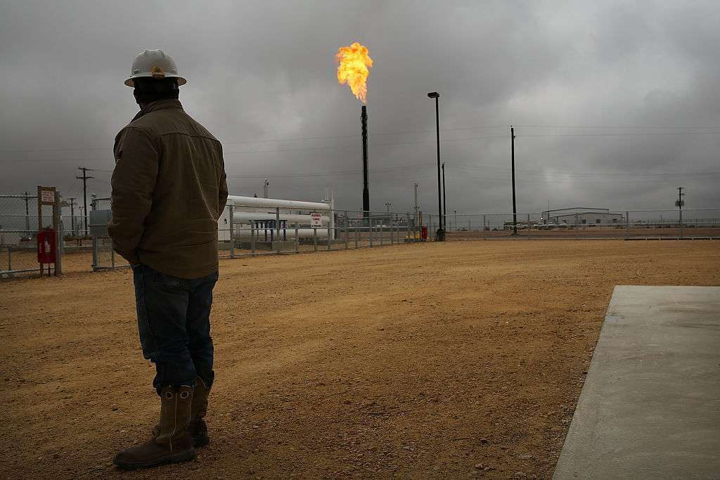 A law passed last year gives the EPA more money to monitor methane emissions. Flared natural gas is seen burning off at the Deadwood natural gas plant at Garden City, Texas, in 2015. 