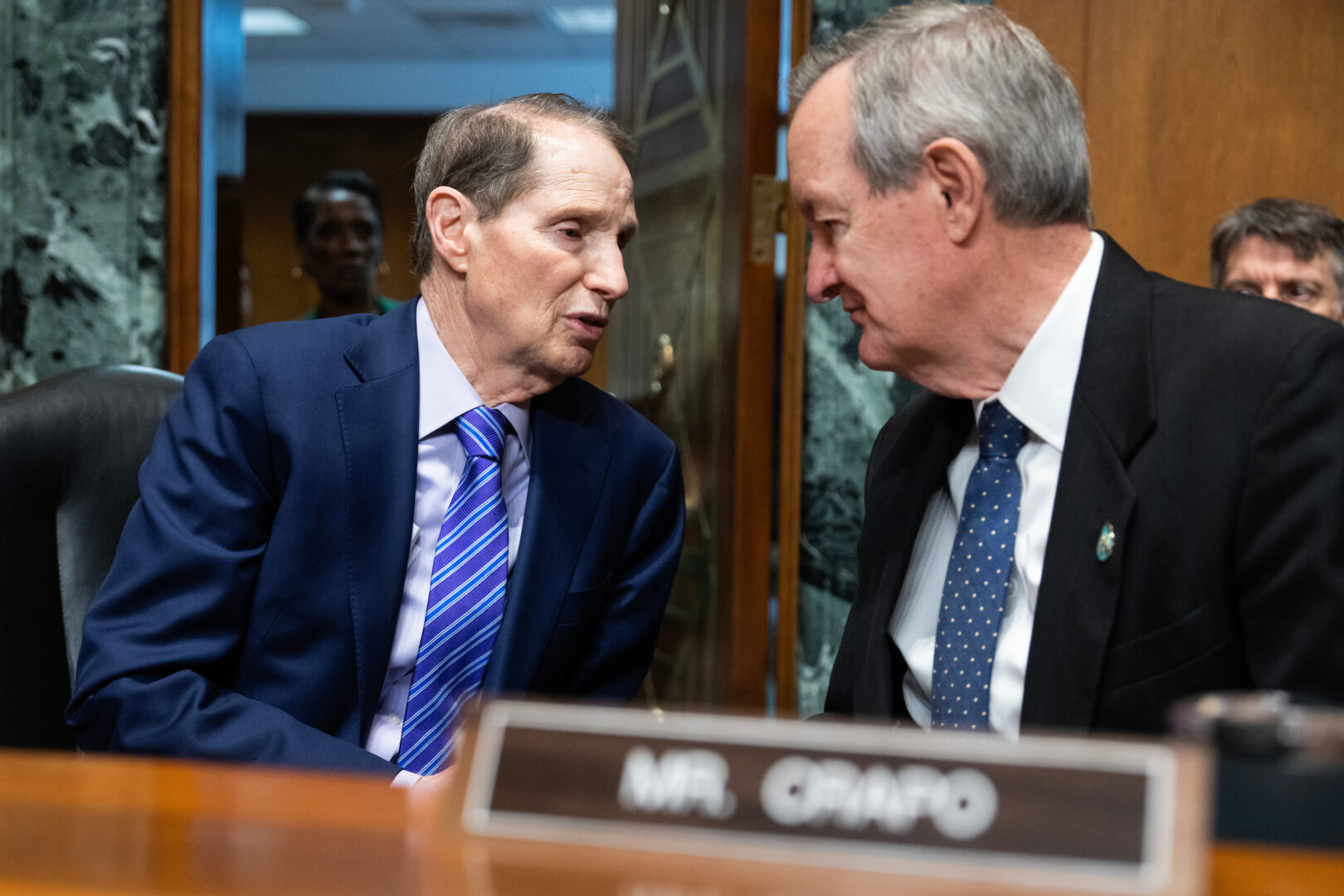 Senate Finance Chair Ron Wyden, left, pictured talking with ranking member Michael D. Crapo before a hearing in March, says he will work with other committee Democrats to come up with a “menu” of possible revenue raisers.