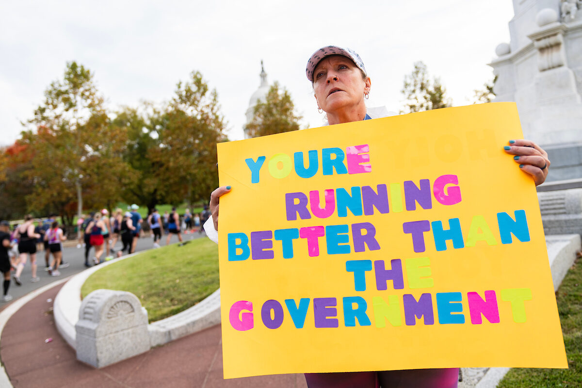 A spectator encourages runners at the Peace Monument during the Marine Corps Marathon on Oct. 29, 2022.