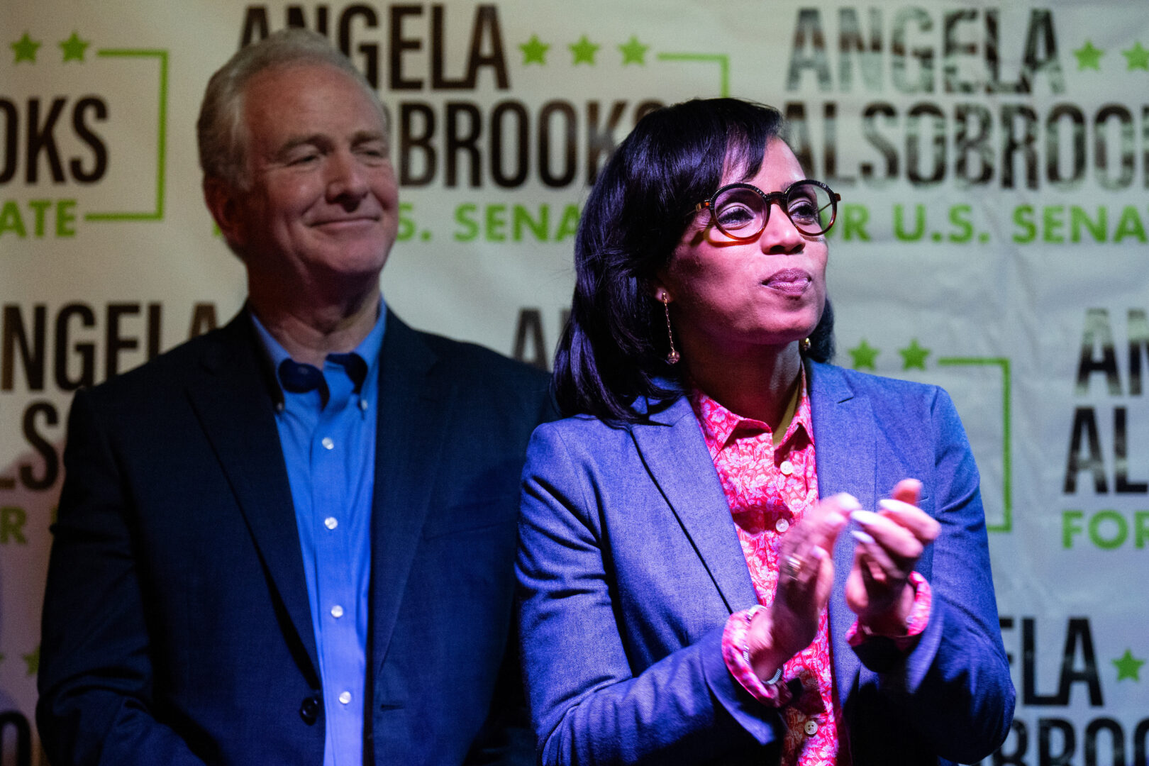 Angela Alsobrooks, Democrat running for U.S. Senate in Maryland, claps with Sen. Chris Van Hollen, D-Md., as local officials speak during her “All in for Angela” campaign event at McGinty’s Public House restaurant in Silver Spring on April 24, 2024. 