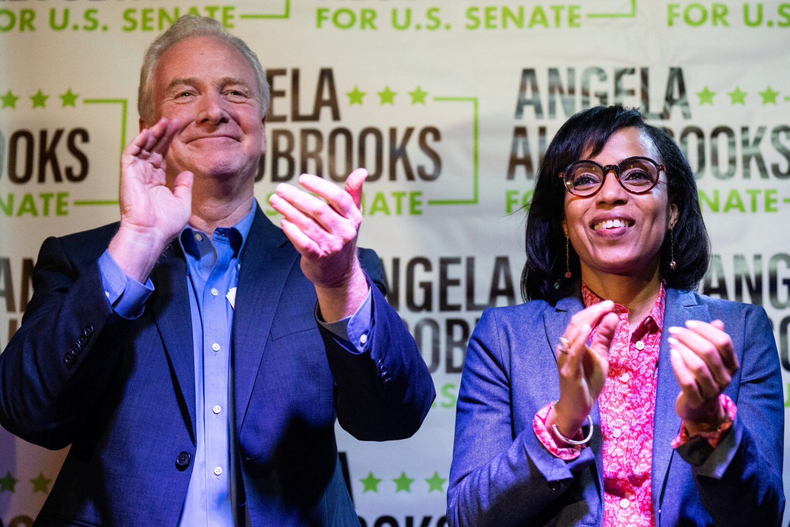 Democratic Senate candidate Angela Alsobrooks claps with Maryland Democratic Sen. Chris Van Hollen as local officials speak during her “All in for Angela” campaign event at McGinty’s Public House restaurant in Silver Spring, Md., on April 24. 