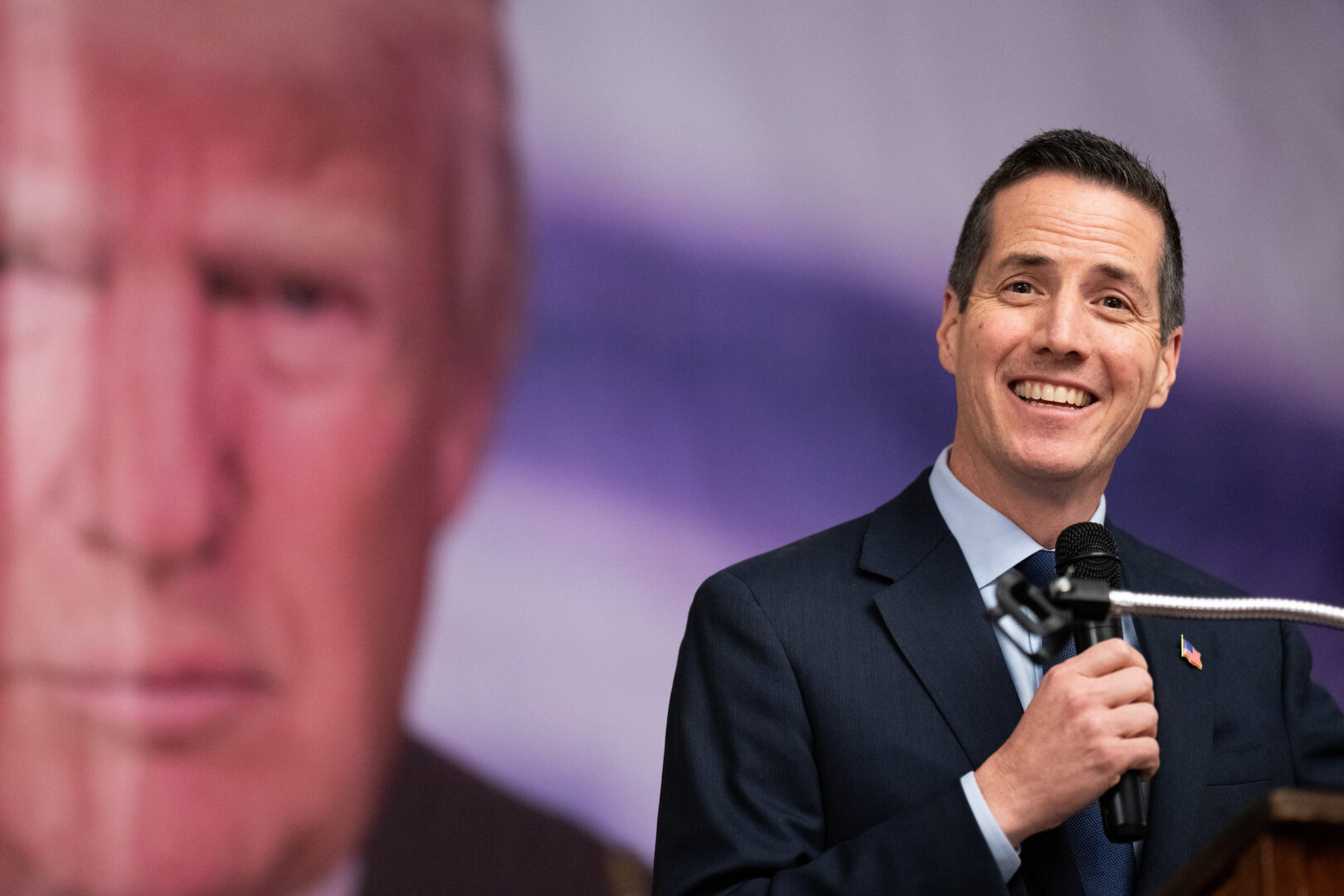 Republican Bernie Moreno, who won Tuesday's Senate primary in Ohio, speaks Friday in Salem, Ohio, at the Columbiana County Lincoln Day Dinner in front of a blown-up photo of former President Donald Trump.