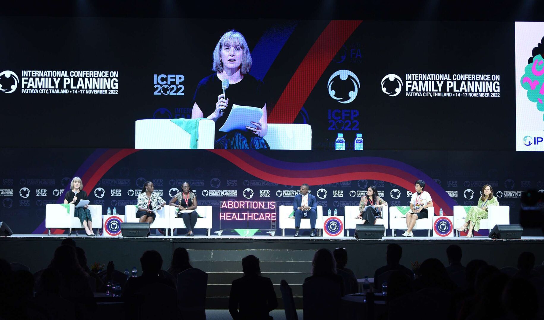 Beth Schlachter, interim director of global advocacy and U.S. representative for the International Planned Parenthood Federation, is seen on the screen moderating a panel on abortion rights at a Nov. 16 panel in Pattaya, Thailand.