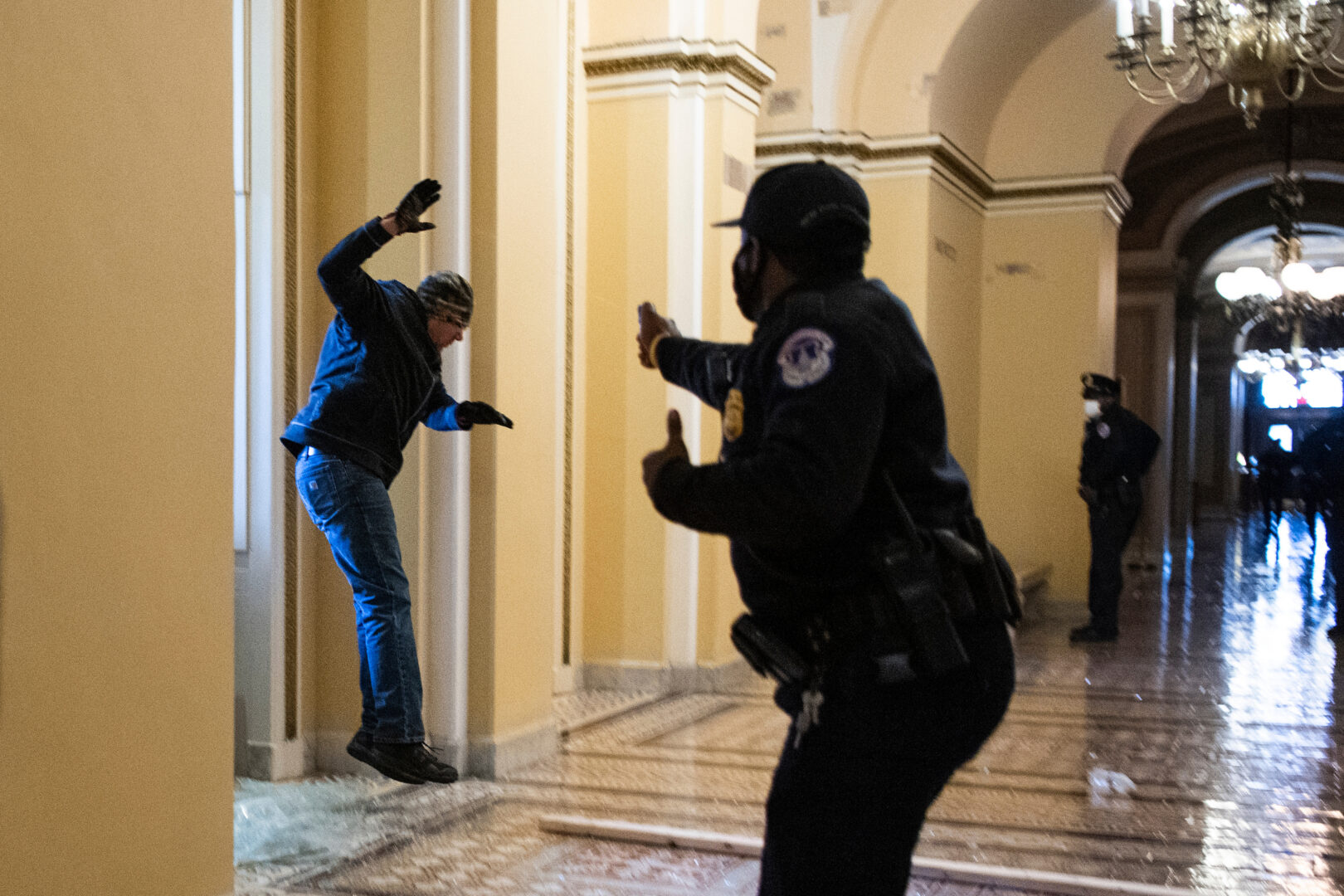 A Capitol Police officer confronts a rioter who broke through a window on the first floor of the Capitol on Jan. 6, 2021. 