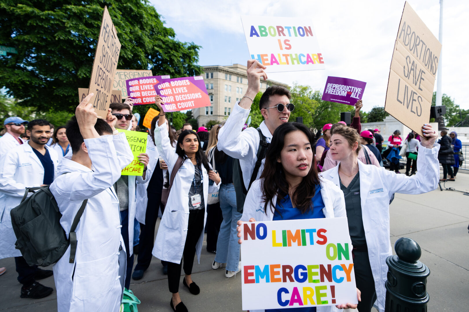 Health care workers hold signs outside of the Supreme Court before oral arguments in April in a case about Idaho's abortion law and a federal law about emergency room treatment. 