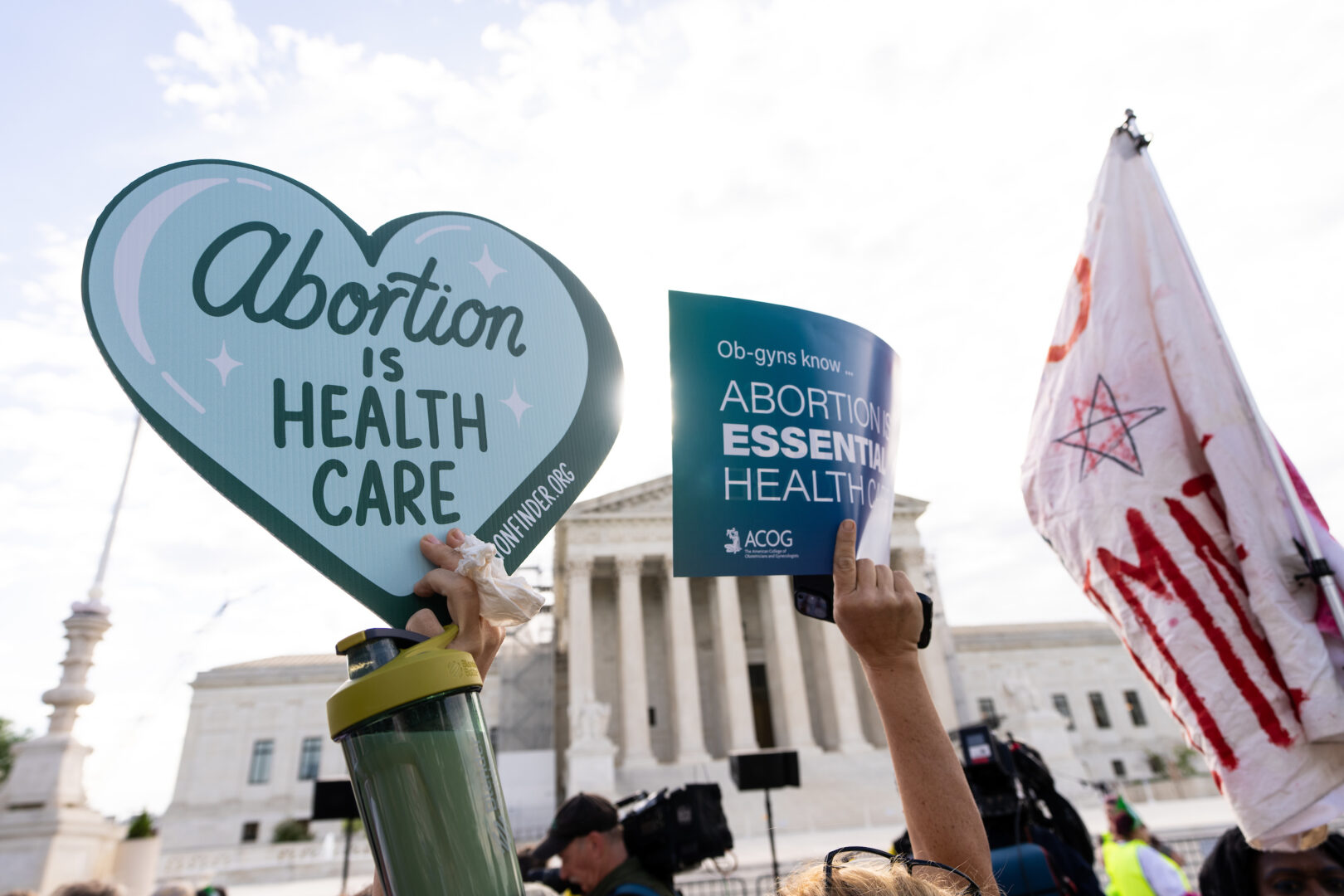 Demonstrators hold signs outside of the Supreme Court before oral arguments in April over Idaho's anti-abortion law. 