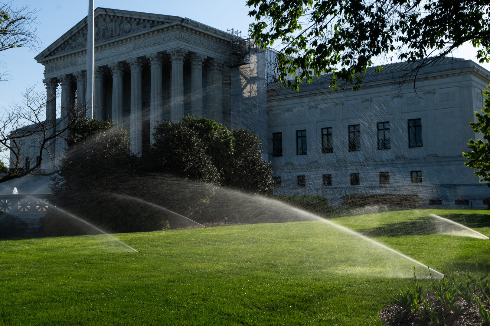 Sprinklers water the lawn in front of the Supreme Court in April. 