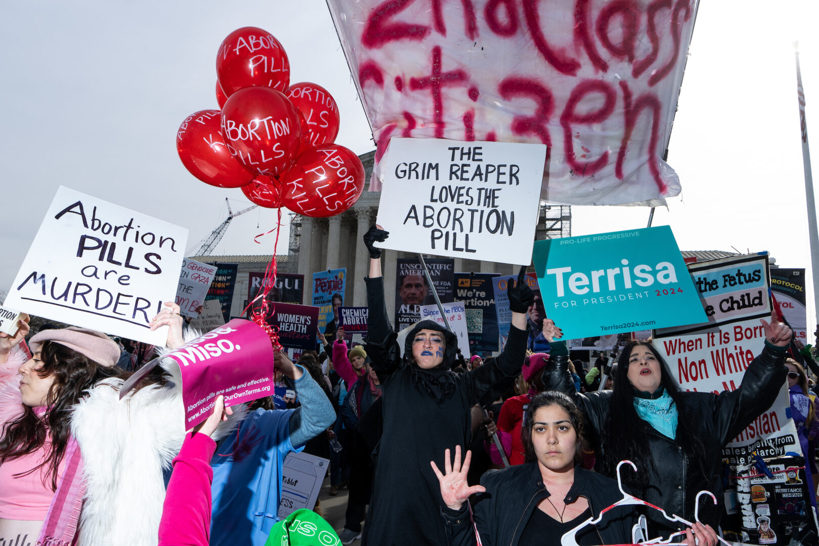 Activists protest at the Supreme Court as the justices hear oral arguments in the Food and Drug Administration v. Alliance for Hippocratic Medicine case on March 26.