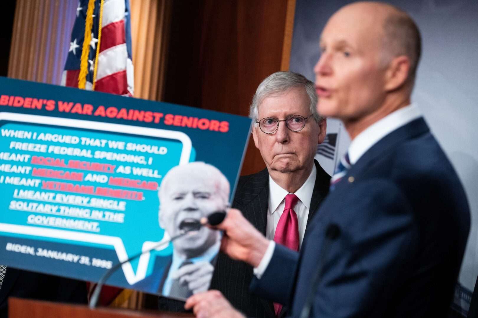 Senate Minority Leader Mitch McConnell, R-Ky., and Sen. Rick Scott, R-Fla., right, pictured at a news conference with a "Biden's war against seniors" poster.