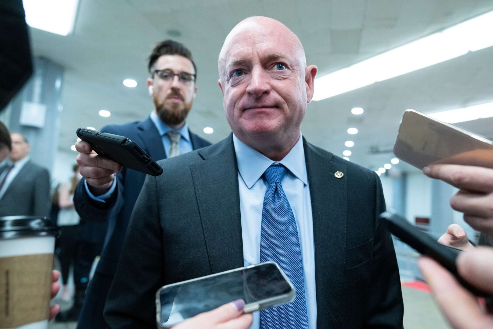 Sen. Mark Kelly of Arizona, one of several Democrats who signed on to a bill that seeks to keep pandemic border restrictions, talks with reporters in the Capitol last week. 
