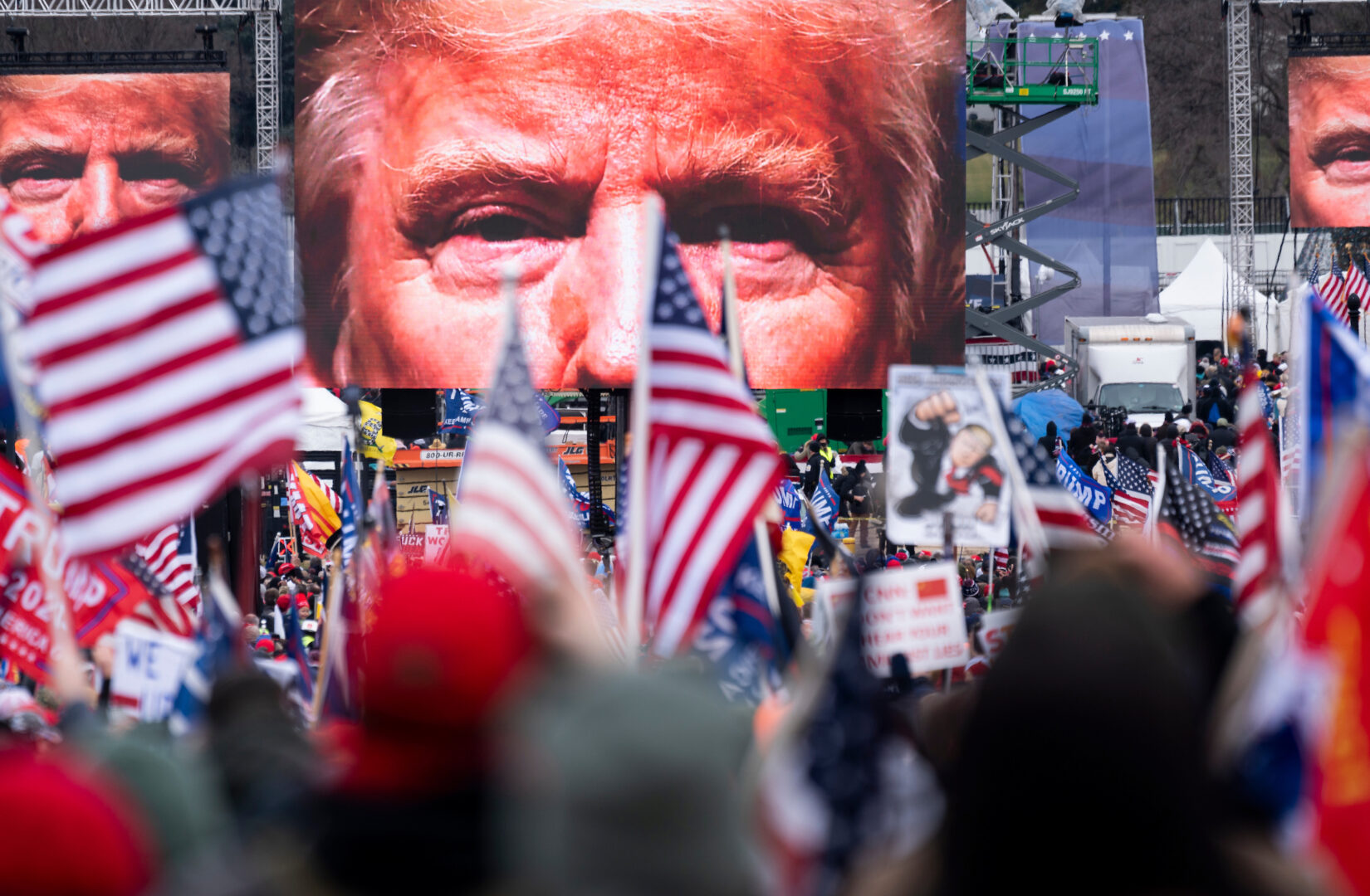 An image of President Donald Trump appears on video screens before his speech to supporters from the Ellipse at the White House on Jan. 6, 2021, before Congress was to certify electoral votes declaring Joe Biden the winner of the 2020 election. 