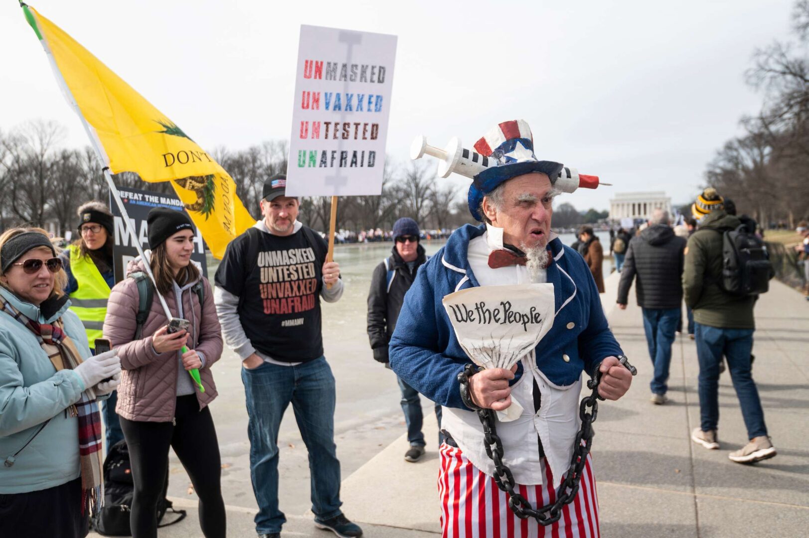 A man dressed as Uncle Sam with a syringe through his hat is seen at a protest against virus vaccine mandates at the National Mall on Sunday, Jan. 23, 2022. 