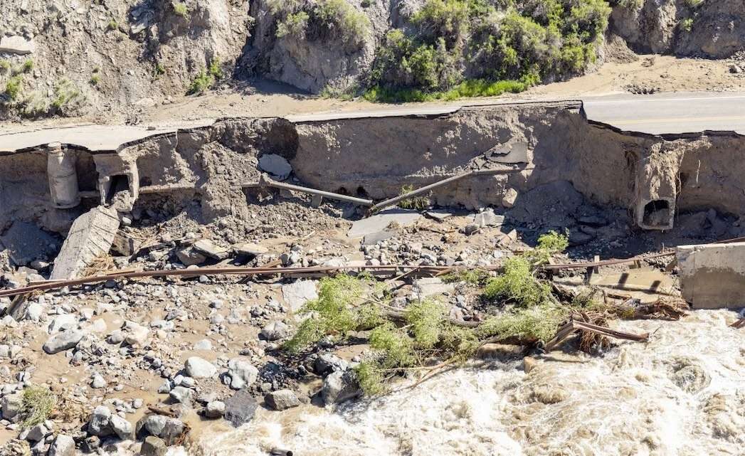 In this photo provided by the National Park Service, the Yellowstone National Park's North Entrance Road is washed out after flooding on June 16.